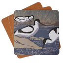 Square tablemat featuring lino print form Sue Welfare of avocets on waters edge with grass background. 
