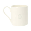 An off-white ceramic mug with a small, minimalist pale green egg-shaped graphic printed on the side, shown against a plain white background.