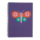 A purple spiral notebook featuring a colorful butterfly graphic on the cover, photographed against a plain white background.