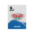 A butterfly-shaped wooden pin badge displayed on its branded backing card. The pin features pink wings with heart-shaped centers, green lower wings, and a pink body.