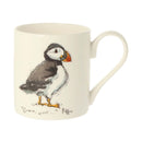 An off-white ceramic mug featuring a painted puffin illustration on the side.