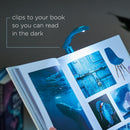 Really Tiny booklight Blue in use clipped to a book with dark background from Campany called IF