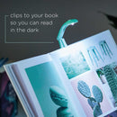 Mint Green Really Tiny booklight from comany called IF clipped on a book to show reading in the dark