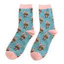 Brown otters pair wearing festive hats on a teal sock with pink toe and heal. 