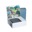 A dark gray zippered pouch with a silver snap button, displayed inside an open white presentation box. The box lid features a printed lifestyle photo of a family outdoors, and a blue circular 'Viking' brand logo is visible on the lid.