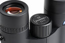 Close-up of a black Perigrine ED 8x32 binocular objective lens and adjustment knob, showing the Perigrine branding and waterdrop lens coating on a white background.