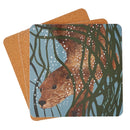 Square tablemat stacked slightly offset, with the top coaster featuring a detailed illustration of a brown otter surrounded by dark green tree branches and white bubbles on a light blue background.