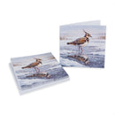 A stack of greeting cards and a single card displayed on a white background, both featuring a winter photograph of a bird standing in shallow water with snow and reflection.